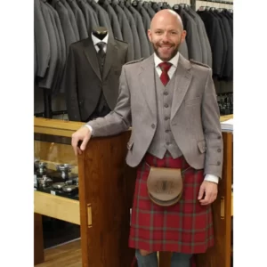 Man wearing full kilt outfit with a Braemar Jacket in Russet Red